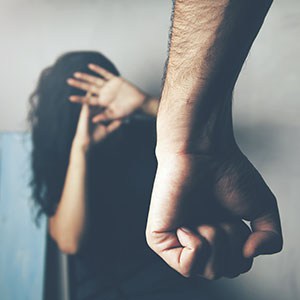 A person is beating his wife symbolizing domestic violence.